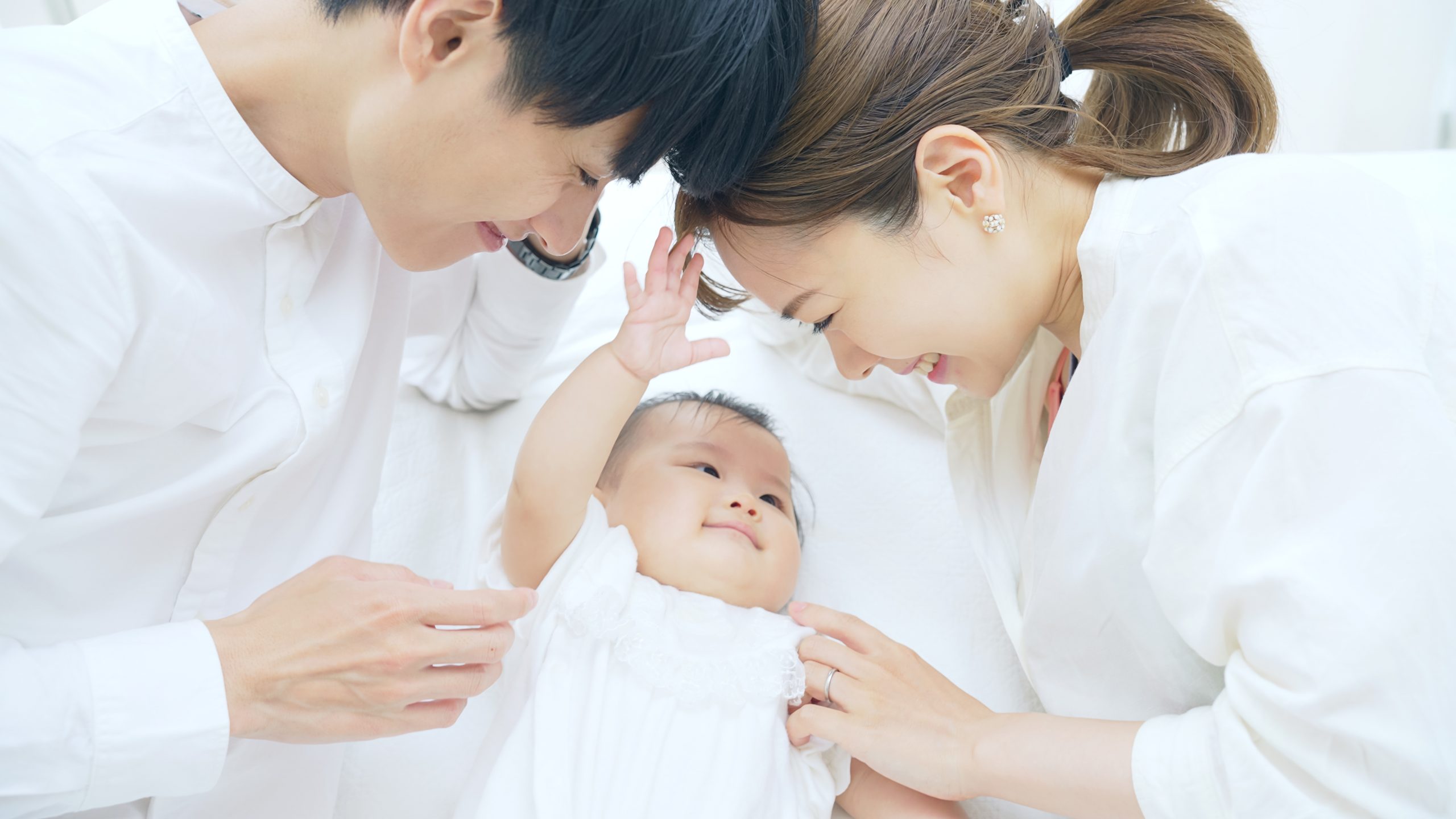 赤ちゃんを寝かしつける両親 子育てイメージ